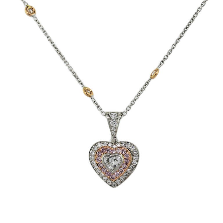 Michael Beaudry Natural Pink and White Diamond Heart Shaped Pendant and Necklace. Heart Shaped Diamond is Approx. 0.25ct, Diamond is G/H in color, VS in clarity.Additional diamonds are 0.32ctw of Natural Pink Diamonds and 1.10ctw.  Pendant size is