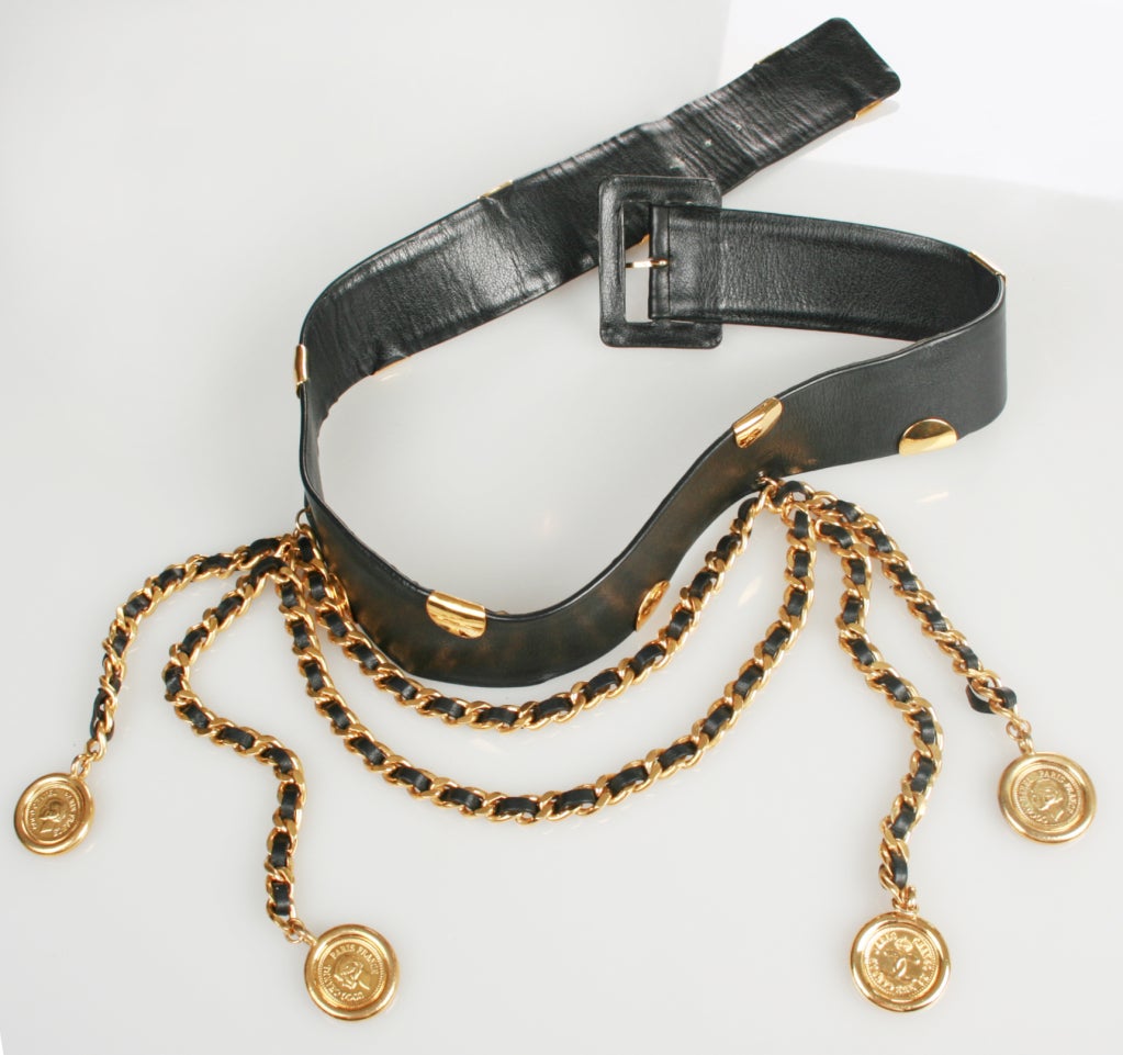 This is a great looking CHANEL belt that will definitely make the outfit.
 It is from season 29 or 1992. 
It will fits size 31.50" thru 33" waist. 
The longest chain hangs down 10 inches.  
The coins are 1.25 inches in diameter.