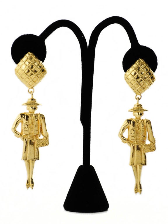 Gold Chanel clip-on earrings in the iconic shape of Coco Chanel. The base of the earrings have a crisscross pattern that replicate the iconic Chanel quilted purse. Earrings measure 3.25