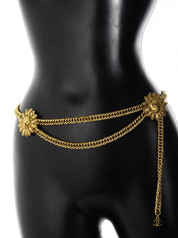 Presented here is a vintage belt from Chanel. This gorgeous gold tone chain belt has two lion head medallions. There are tiny CC logos encircling the lion head on the medallions of the belt. The belt can function as both a belt or a fabulous gold