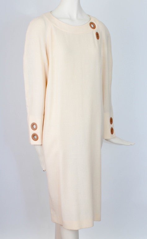 Dress presented by Gianfranco Ferre in ivory. This dress is 100% wool crepe and features unique leather ring detail, dolman sleeves and back zipper closure. Unlined

Measurements: 

Sleeve Inseam: 15.5