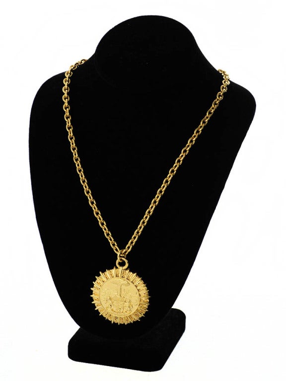 1980's Chanel pendant necklace with round sunburst style pendant, with crest.