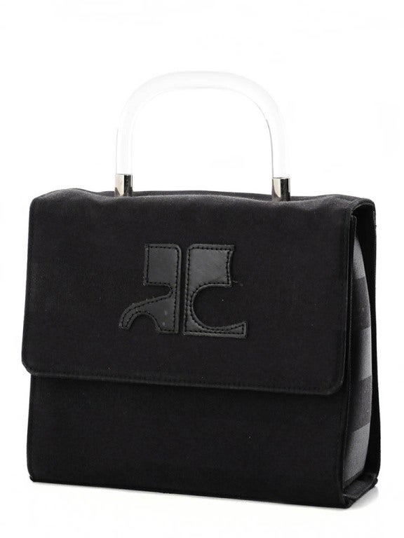 1980's Courréges box handbag in black. Alternating textured stripes and lucite handle. Snap closure and logo on front.