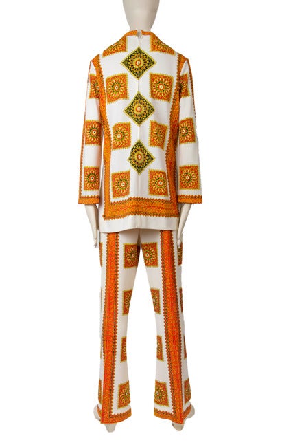 Absolutely Fab Tunic top and pant suit set ensemble in orange and creme mandala print motif presented by Mr. Dino features stand up collar, long sleeves, and back zip closure. Pants feature side zip with interior button tab closure.
Label: Mr. Dino