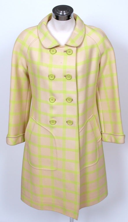 Coat presented by Courreges in a beautiful heavy pale, powder pink cream wool with lime green window pane plaid. This coat features an eight button double-breasted topper with covered button holes, Peter Pan collar, french tulip cuffs, unique side