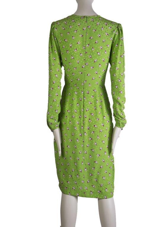 This is a vintage 100% silk Ungaro dress. Bright, vibrant green with flowers. Dress has full length sleeves with silver rose buttons at the wrist. Ruching at the waist on the left side. Zips at the back.