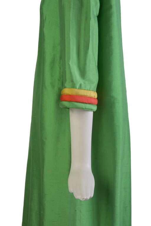 Lanvin Boutique long green silk dress with long sleeves and quilted stripe cuffs and hem in yellow, orange and green very minor fraying along hem.  Zippered back. The bottom and sleeves of the garment have 3 rows of tufted fabric. At the bottom, it