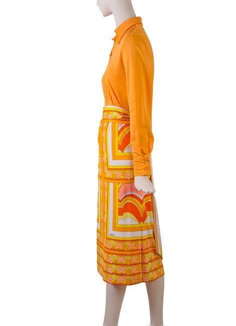 This gorgeous vintage 1960's Mr. Dino three piece orange bodysuit top, skirt and matching belt.  The top features a collar and button front.  The elastic waist skirt features a slit and has a lovely orange, yellow and pink daisy print as does the