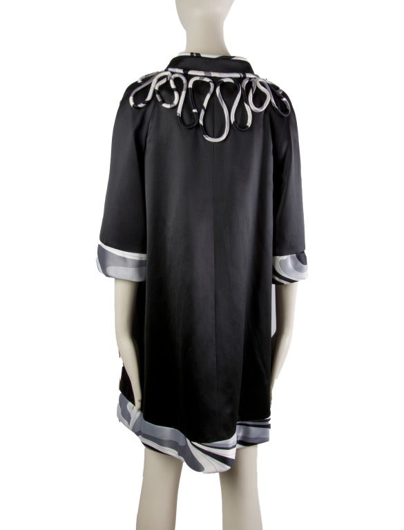 This Emilio Pucci two piece ensemble features a black open back, silk dress with grey, white & black trim, including an around the neck cross over to the back and a matching coat with matching ribbon trim around the front and trim on the sleeves and