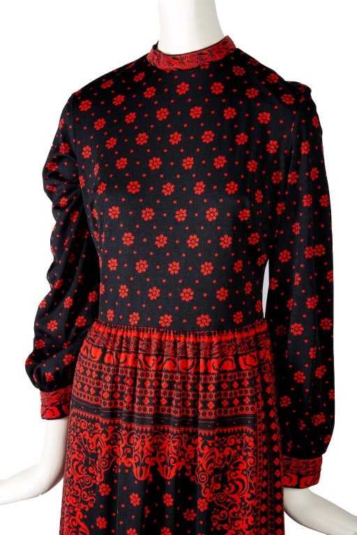 Mr. Dino Maxi Dress
Black with Red Floral Print
Long Sleeves
Short Stand up Collar
Zip up the back

Total Length - 50.5 inches
Bust - 38 inches
Waist - 30 inches
Hips - 25 inches
Shoulder to Cuff - 24.5 inches
Underarm to Cuff - 17.5 inches