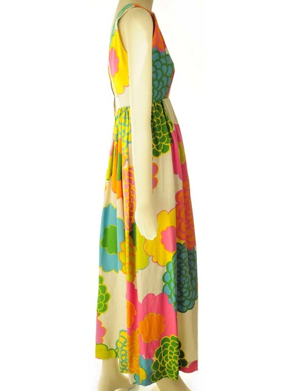 Vintage floral maxi dress presented by Malia in neon colors of teal, green, pink, orange and yellow. This dress features a boat neckline and scoop back with empire waist and gathered skirt. Back lapped zipper closure with hook and eye. 


Bust: