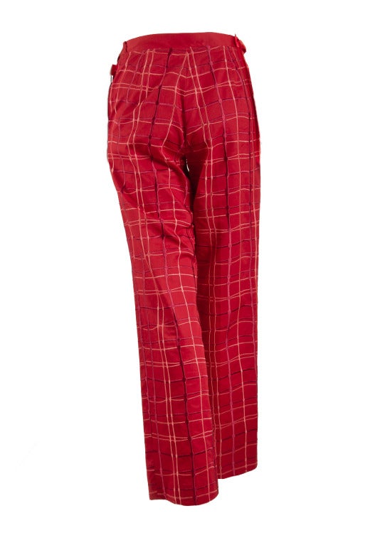 These pants by Bottega Veneta are presented in 100% cotton.  They are red with red plaid embroidery.  The feature a two button closure with side belts.  The purse has two compartments.  One compartment zips shut, the other has an additional