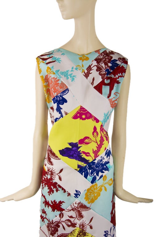 This dress is presented by Christian LaCroix in 100% silk.  It is patchwork of butterfly, peacock and floral print.  It has a zipper and eye hook closure up the back.  Marked size 42