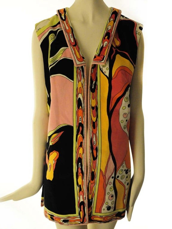 Presented here is an extremely rare vest jacket from Emilio Pucci. This vintage 1970's masterpiece is a museum worthy example of early Pucci. Vest Jacket presented by Emilio Pucci in navy blue cotton velvet with vibrant shades of pink, orange and