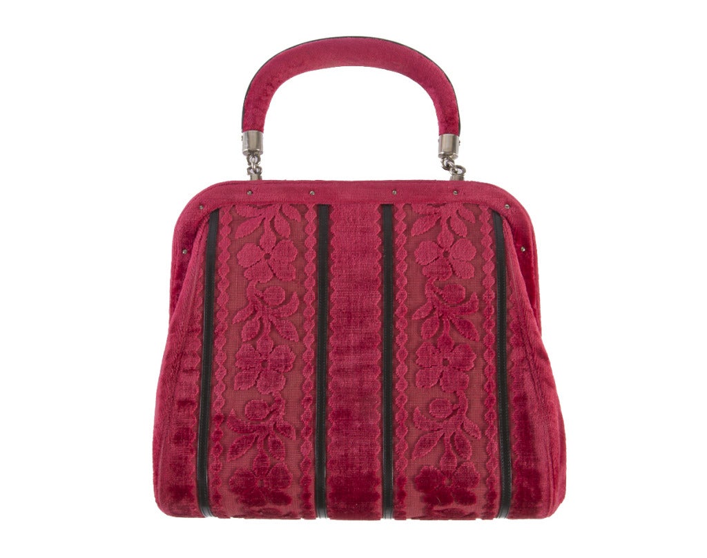 Roberta Di Camerino Vintage Handbag has flower cut velvet, black leather stripes, trim and interior.  It features sterling silver hardware.
The dimensions are: 9