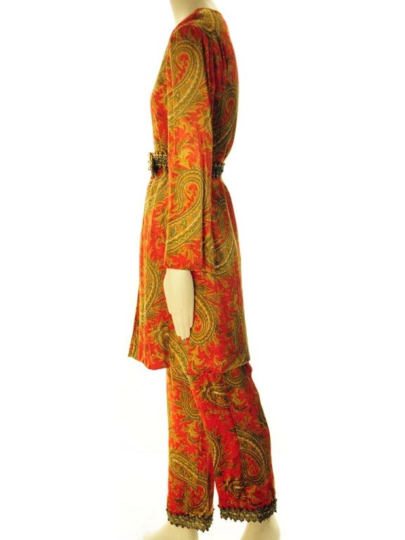 This is a monumental museum worthy example of Bill Blass's fashion design. The beautiful paisley pants with large tunic is adorned with an ornate belt. The paisley is absolutely magnicent and in great condition. The beautiful velvet paisley fabric