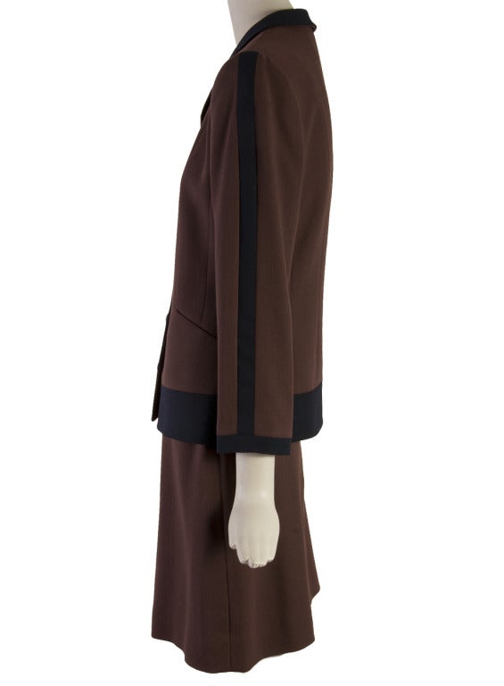 Louis Feraud brown with black trim wool two piece skirt set.  Marked size 6. The jacket has a collar and a button front with shoulder pads.  The skirt has a zipper closure.  Each piece is lined.  
Jacket Measurements:
Bust: 36