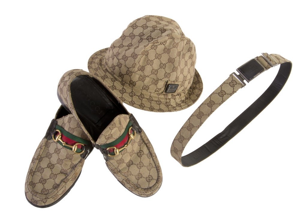 This four piece Gucci set includes women's loafers, size 9.5B, men's loafer's 10.5D, a medium size hat, and a 36