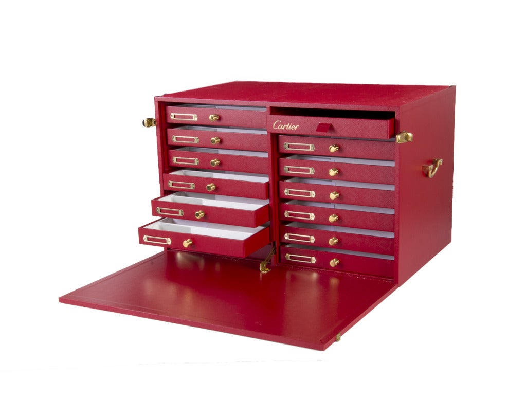 This authentic Cartier is has several inner drawers to hold fine jewelry and watches and two additional boxes for watches complete with foam inserts.  It has the Cartier logo in gold with gold tone hardware.  Also comes with the Cartier book, A