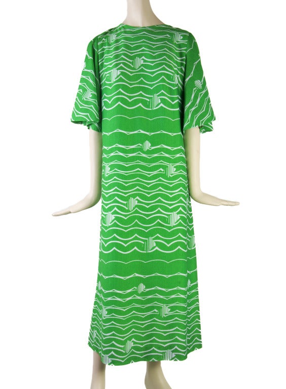 This vintage 1960's maxi dress is presented in bright green with Op Art white striping.  It is lined, has a zip up the back and features angel sleeves.  Size is not marked, please see measurements.