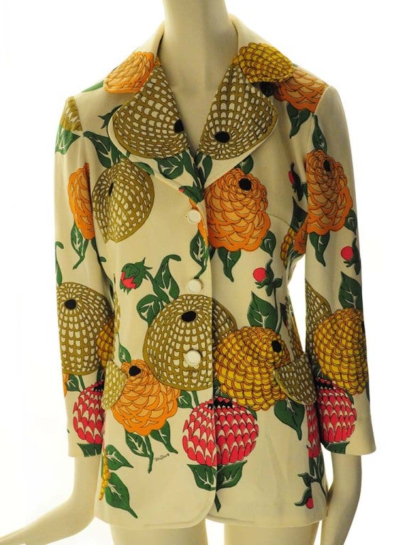 Vintage cream colored Mr. Dino blazer with unique cone flower print in vintage colors of mustard, orange, yellow and hot pink. This blazer features a round notch collar, three button closure, two round faux flap pockets and 3/4 sleeves.