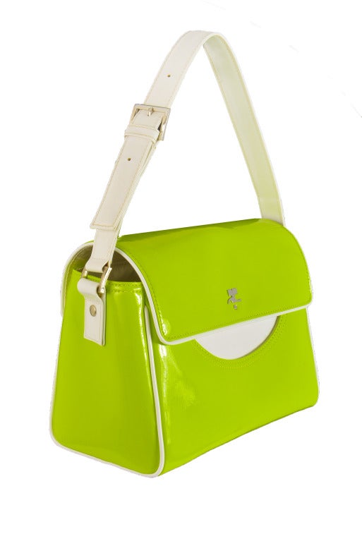 Vintage Courreges Lime Green and White Vinyl Handbag
This bag has a fold over snap closure with silver tone hardware. The strap is adjustable like a belt buckle. The inside is lined and features four compartments, with one being a zipper