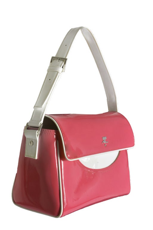 Vintage Courreges Hot Pink and White Vinyl Handbag
This bag has a fold over snap closure with silver tone hardware.  The strap is adjustable like a belt buckle.  The inside is lined and features four compartments, with one being a zipper