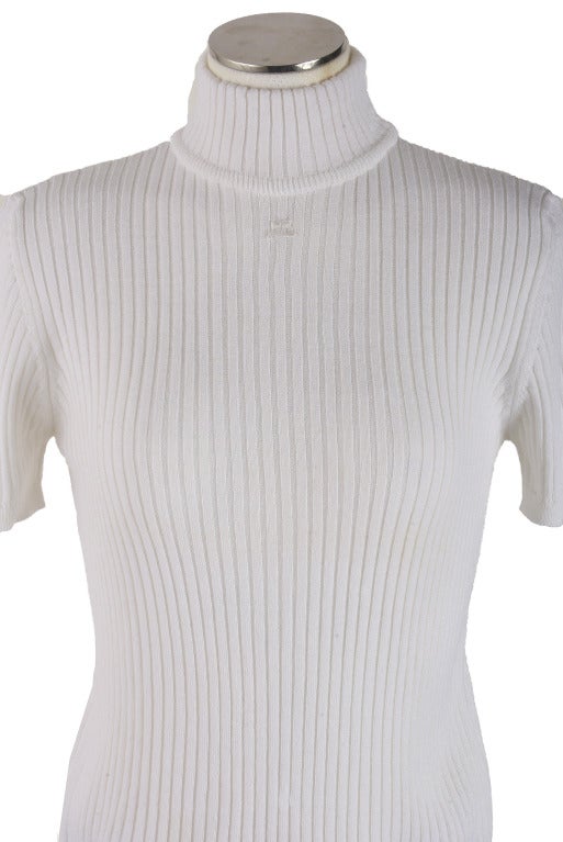 This knit sweater by Courreges is presented in warm white wool acrylic blend.  It has banded sleeves and waist.  It is a marked size large.  It has never been worn. 

50% Merino Wool
50% Dralon