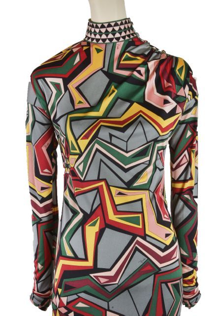 This fabulous mod print by Emilio Pucci adorns this dress with green, red, gold, peach, maroon and black.  It has a mock turtleneck, long sleeves and a button closure on the shoulder.  This is a must have dress for any Pucci fan!