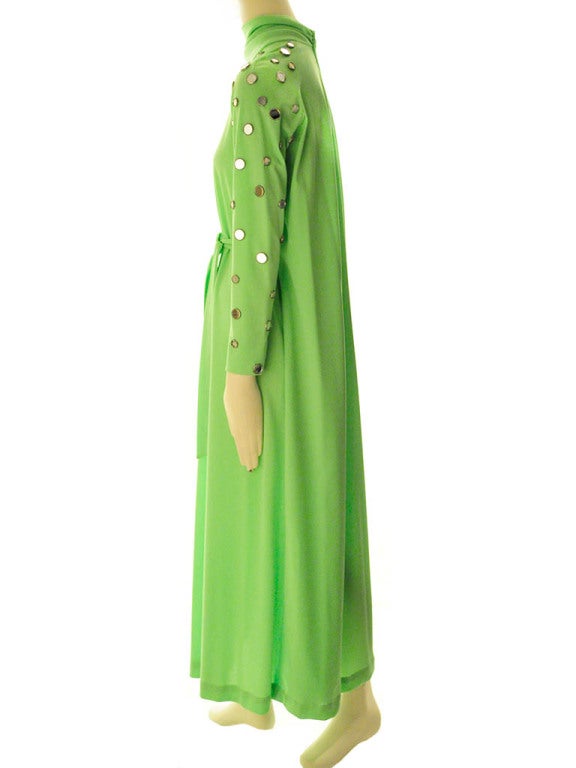 Lime green mirror disc maxi dress features rushed stand up collar; long sleeves sprinkled with silver tone mirrored discs accent detail; interior/exterior detachable belt; and invisible  back zip with hook & eye