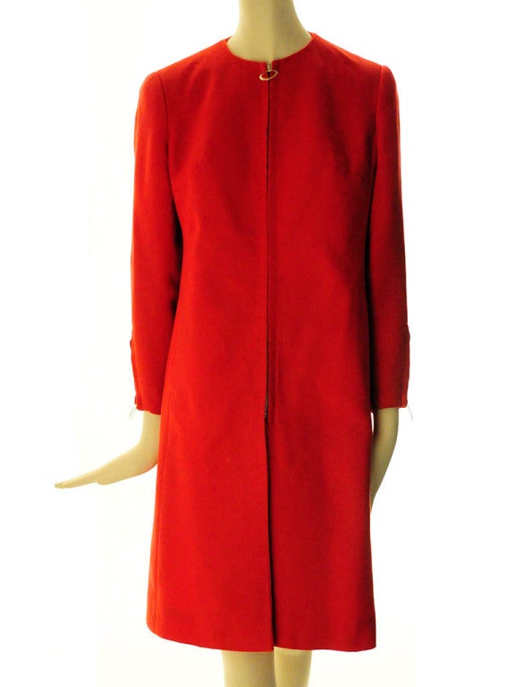 Coat/Dress presented by Mary Quant's Ginger Group features jewel neckline; darted bust; long sleeves; O-ring tab zip cuffs ; two lower front on seam pockets; covered O-ring tab zip front closure. Lined.
Label: Mary Quant's Ginger Group Made in