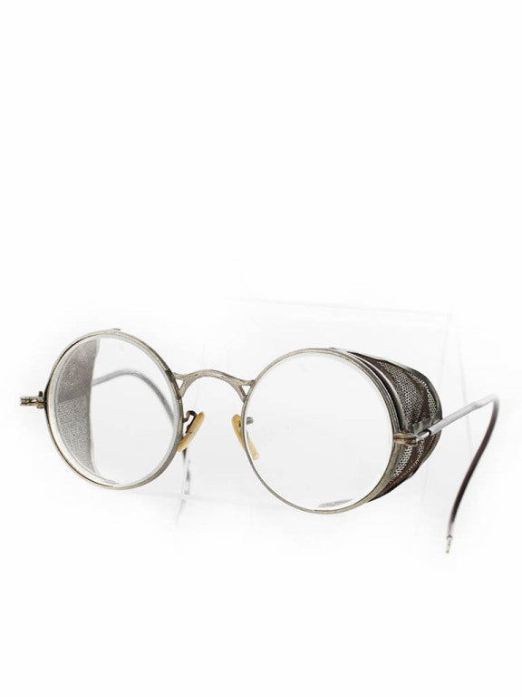 Antique 1930's Welsh Motorcycle safety glasses/ goggles. Mesh shield folds to the center and temple (ear piece) fold to the front for storing. Very unique. Would make a great display piece. This museum worthy pair of glasses is in excellent