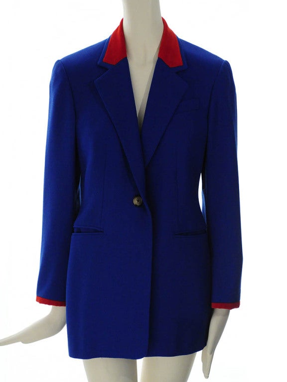 Vintage Hermes tailored blazer in royal blue wool with red velvet detailing on collar and sleeve hem. Jacket features single button front closure, left chest single-welt pocket, two double-welt pockets at hip, three button sleeve closure and two