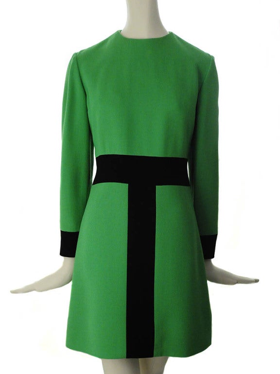 Vintage green black geometric wool crepe dress presented by Jean Patou Boutique features jewel neckline; long sleeves with black cuffs; black waistline with back button tab; and back zip with hook & eye closure that is delicately hand sewn.