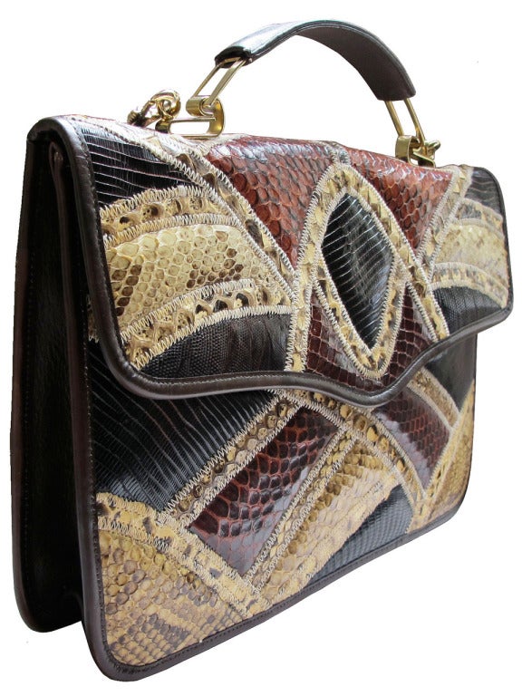 Exotic snake and lizard skin patchwork purse with zig-zag stitching. Versatile short leather and gold metal hardware handle and detachable brown leather and gold metal shoulder strap. This bag is trimmed with thin brown leather banding; interior