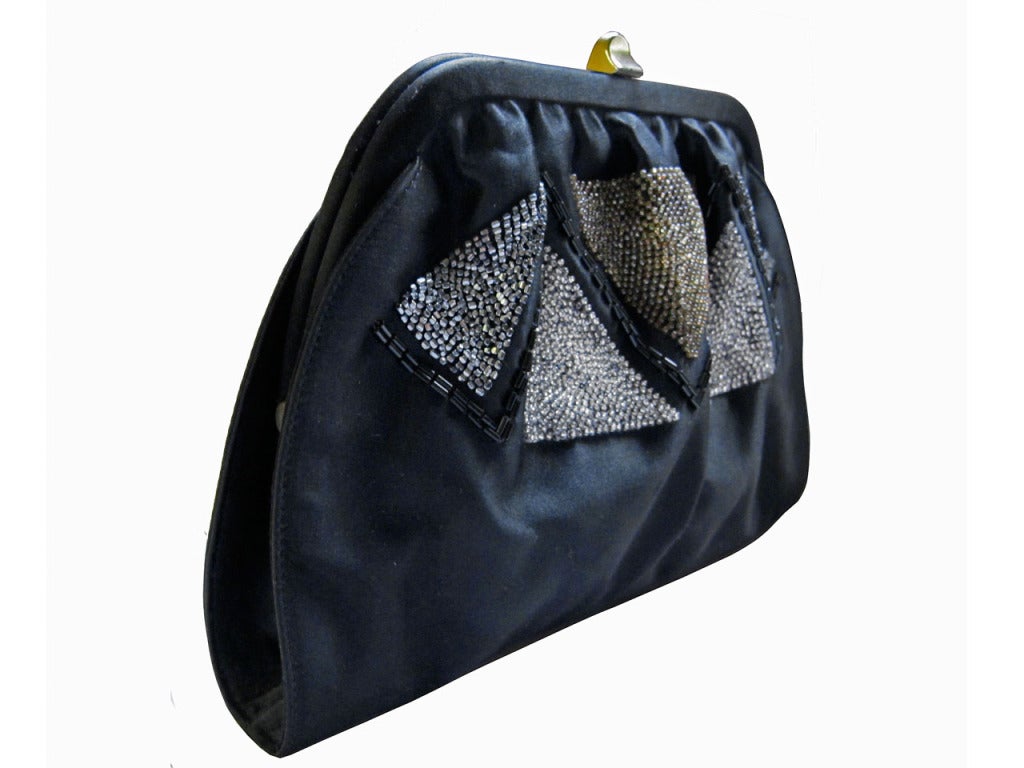 Fabulous black satin pouch purse with gold tone clasp and beaded diamond pattern design. Versatile shoulder strap that may be snapped on or off - wear as a shoulder bag or as a clutch. Strap drop measures 22.5 inches. Interior with one slip pocket