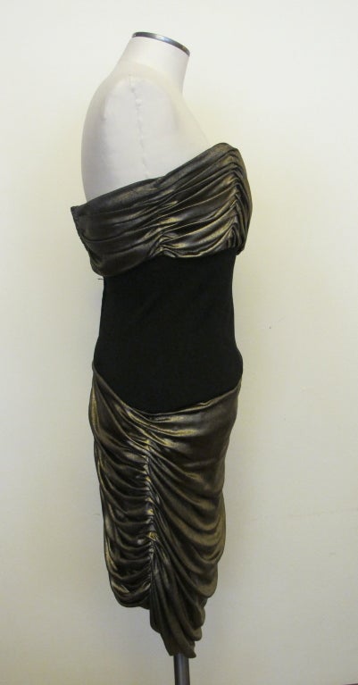 Sophisticated strapless cocktail dress with black-gold lame on ruched bust and skirt. Boning at sides. Back measures 23