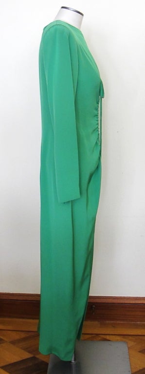 Long-sleeved kelly green silk Oscar de la Renta gown from 1980's-1990's with center front drawstring to adjust ruching. 26 inch center front slit, center back zip and zippers at each wrist. Marked size 6, reads modern size 4-6.

Photography