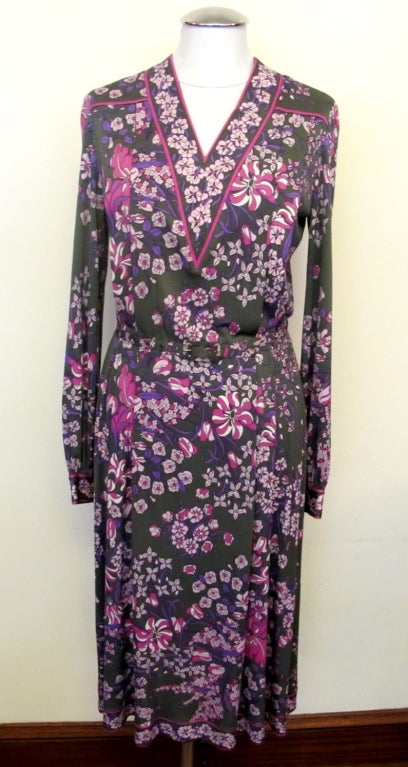 Iconic Pucci blouson style dress enhanced by floral print and avocado green background. Fits beautifully with stretch. 100% pure silk fabric with elastic waist and matching .5