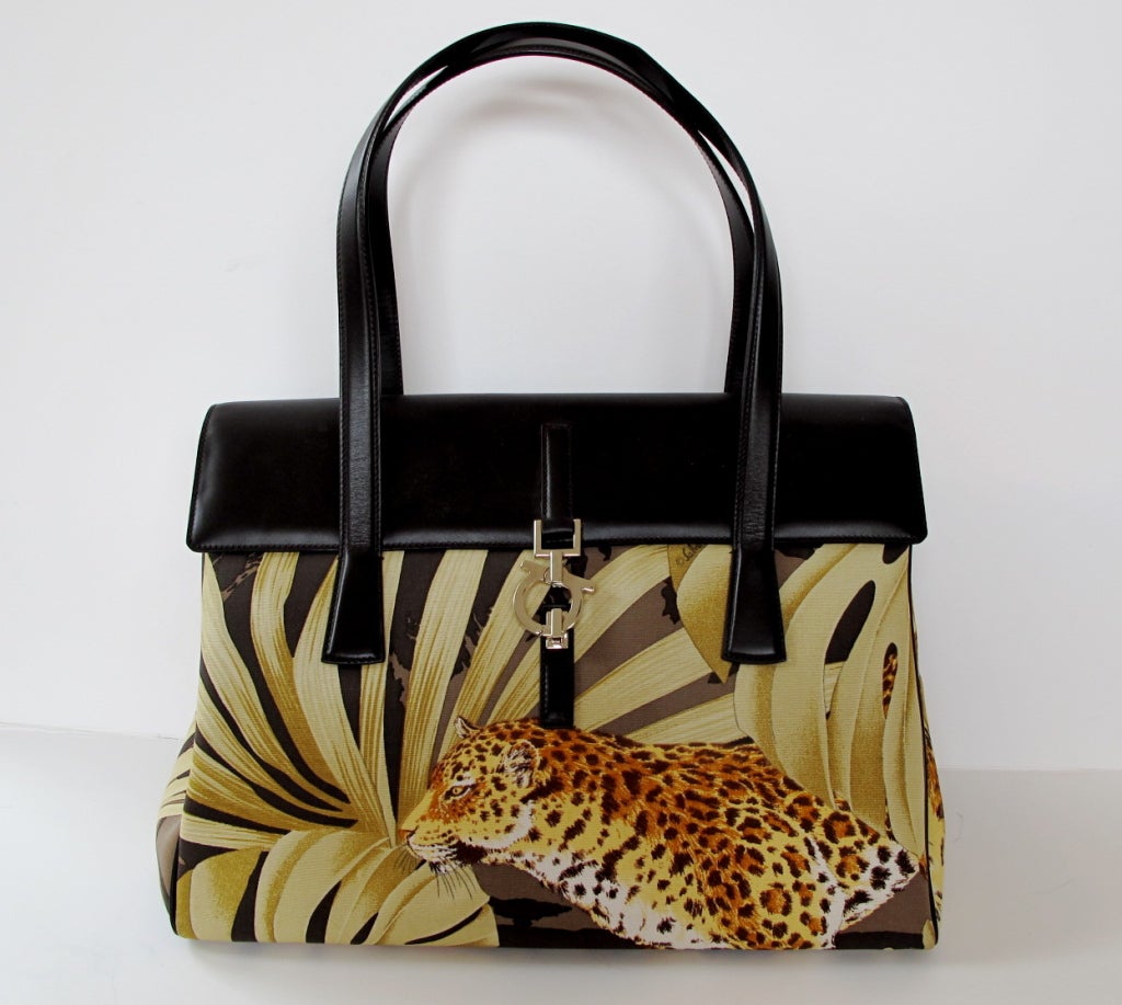 Chic handbag with jungle and leopard design enhanced by brown leather handles and trim. Strap drop is 8 inches.

Photography provided by Roberto Rosas-Mariscal for Helpers House of Couture.