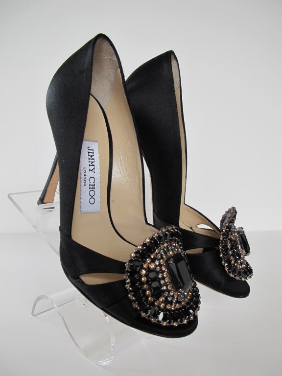 Black Satin Pump with peep-toe and jewel encrusted decoration with black, topaz and smokey rhinestones.

Photography provided Roberto Rosas-Mariscal for Helpers House of Couture.