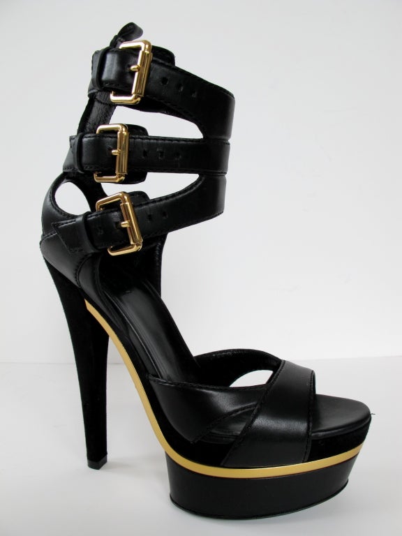 Ultra sexy black leather triple ankle strap Gucci platform sandals with goldtone hardware. These heels feature a 2