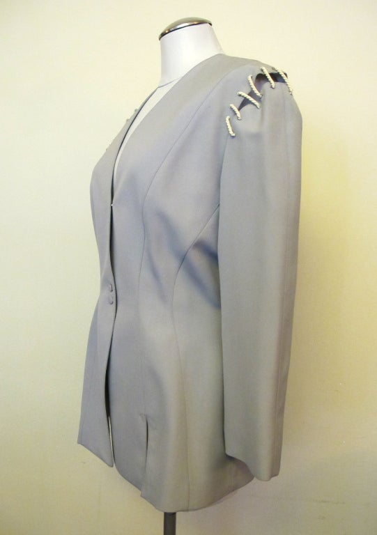 New fitted jacket - light blue grey with slits at the shoulder and right cuff with nautical white cording. Original price with original tag: $3,075.00.