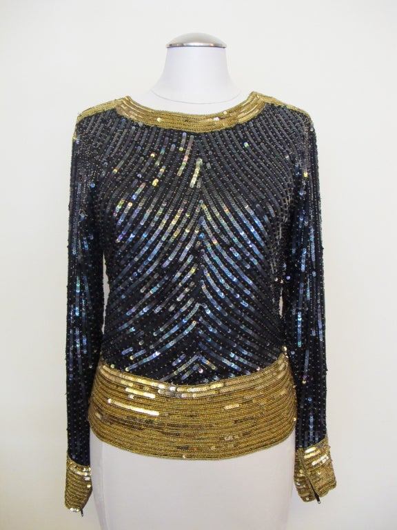 Stunning Yves Saint Laurent Rive Gauche for I. Magnin 1980's blouse embellished with black  bugle beads, black iridescent sequins, gold sequins and gold seed beads. The blouse features hook and eye closure at the left side of the collar extending to