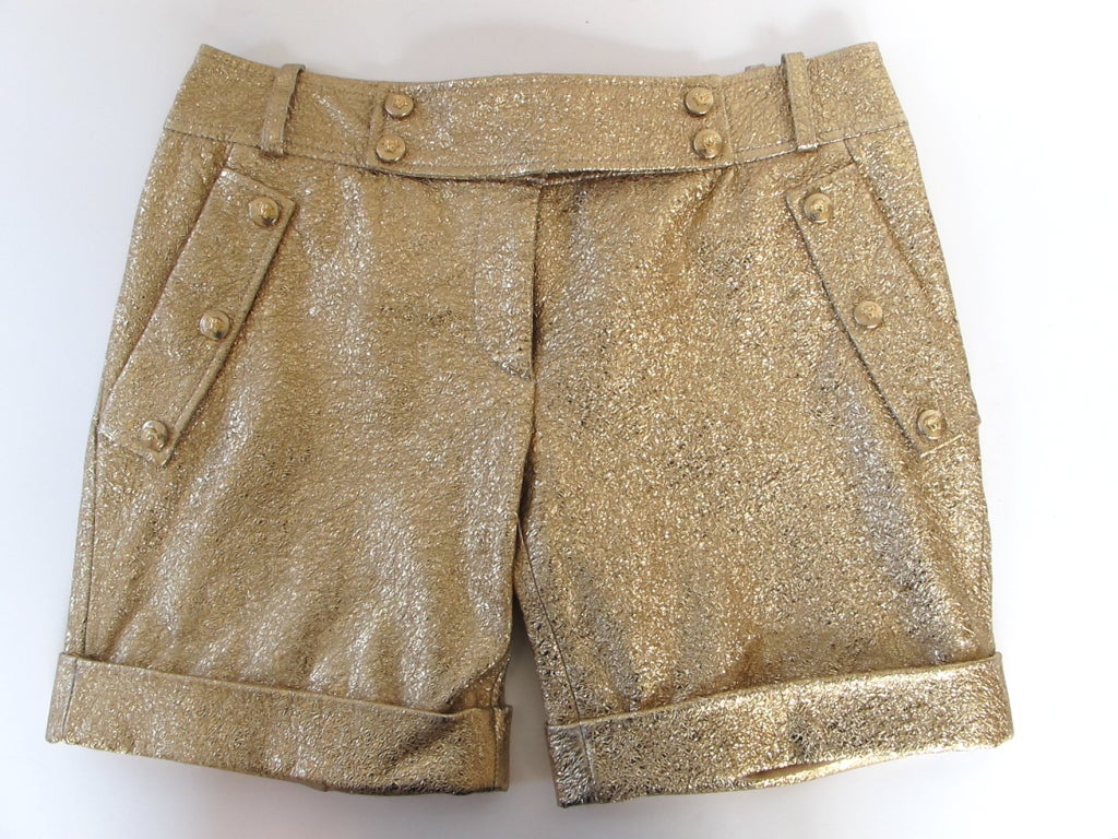 Gorgeous gold leather Versace shorts with iconic Versace medusa head buttons that snap open back pockets, waistband and front pocket foldover flaps.