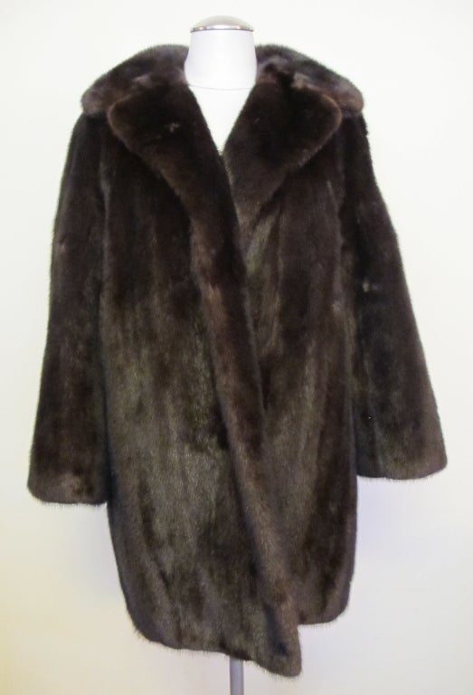 Classic timeless fashion 3/4 coat. Double fur notch collar, 1 row fur facing, raglan sleeves. Trapunto design silk and bemberg lining. Raglan sleeves measure 27 inches long, 16 inch crossback.