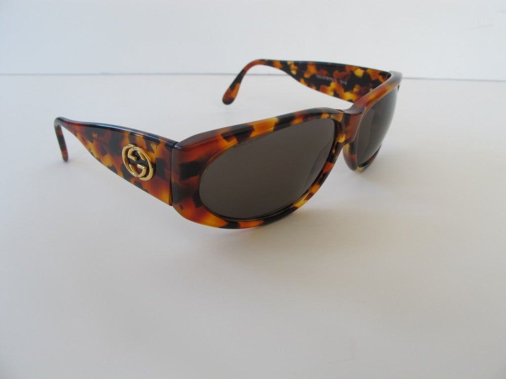 Classic Gucci Sunglasses with Gucci logo on the side of the glasses