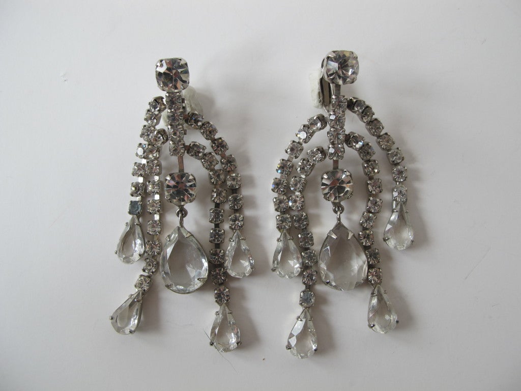 Kenneth Jay Lane chandelier pave rhinestone clip earrings. Fabulous when accompanied by a gorgeous, dramatic evening gown.

Copyright mark below the KJL; circa 1970's