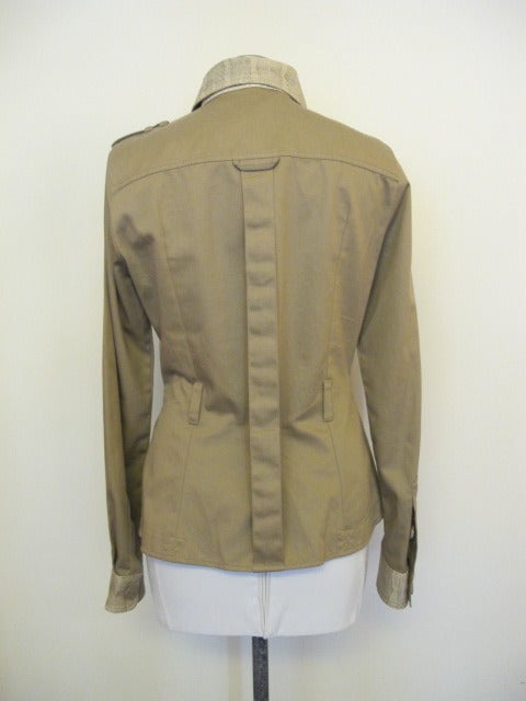 Khaki cotton jacket adorned with water snake detail on collar, front panel, cuffs, buttons and epaulettes on shoulder. Loops attached for belt. Size 42, Bust 36 inches, Length 24.5 inches, Sleeve Length 25.5 inches, Shoulder to shoulder 15.5 inches.