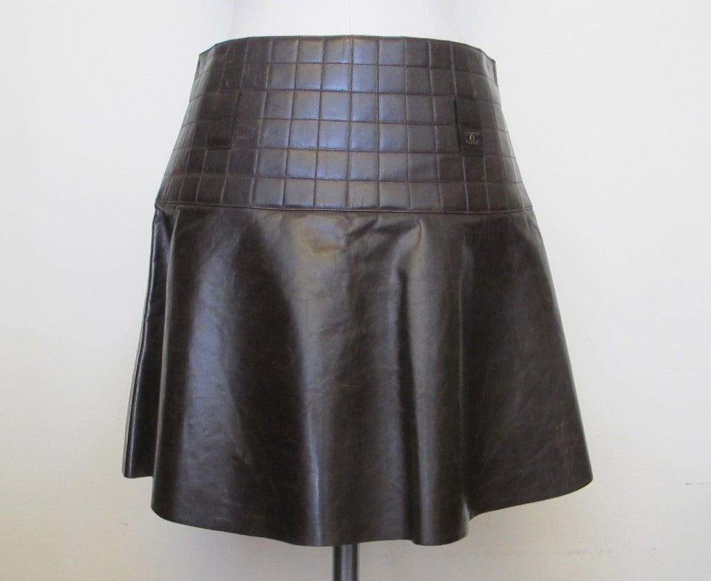 Chanel rich brown quilted leather skirt with Chanel logo on left tab. Made in 2002